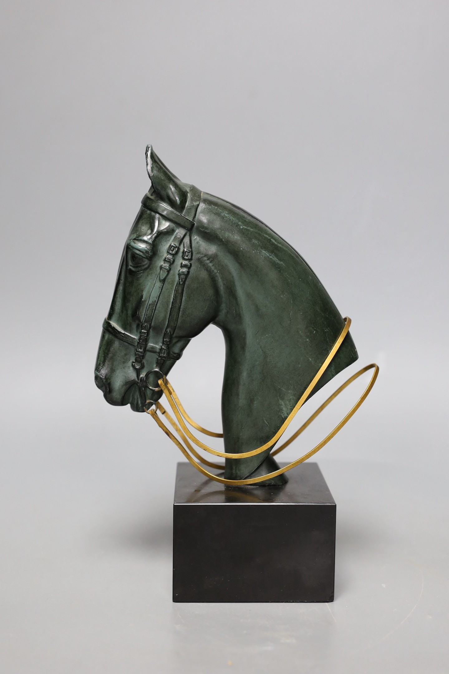 An Art Deco patinated bronze of a horses head on black marble base, 23cms high